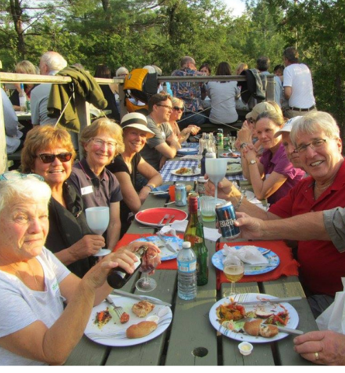 This is a photo of a group of people eating at a picnic table