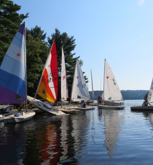 This is a photo of several dinghy sailboats in the sunshine