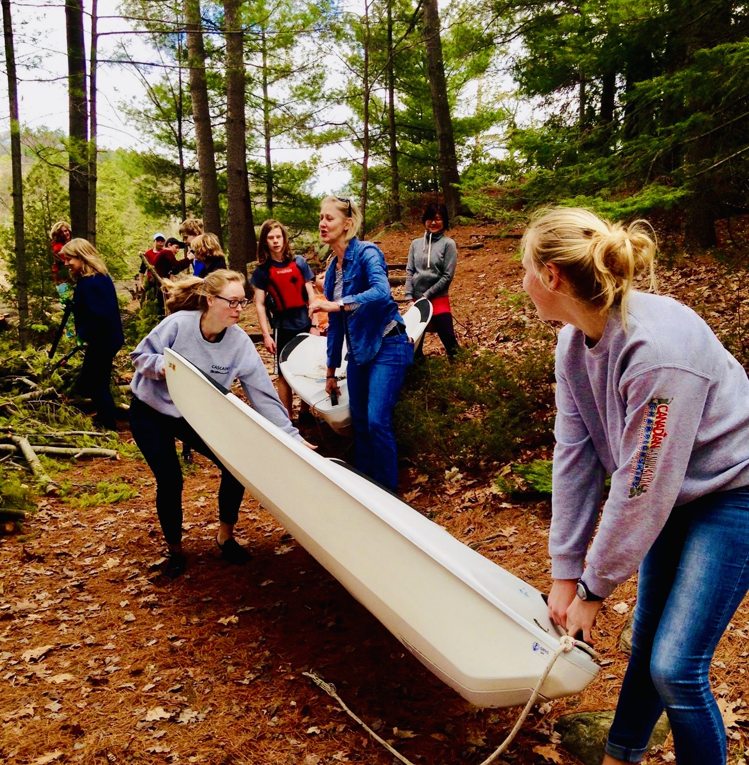 This is photo of a group of people lifting a boat